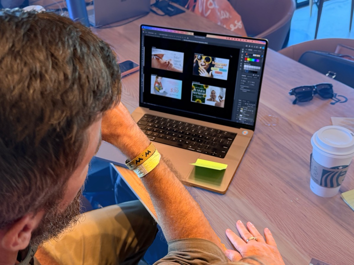 A Schway designer building branded graphics on a laptop